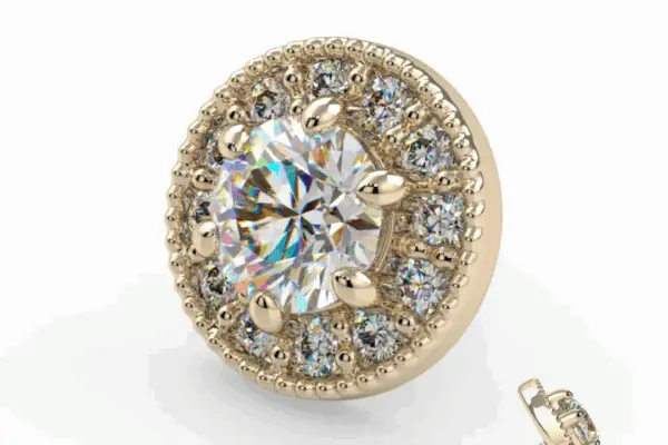 The 14K Catherine is a stud earring with a large round center gemstone, surrounded by a halo of smaller sparkling stones and intricate beaded detailing. The earring back is shown beside it.