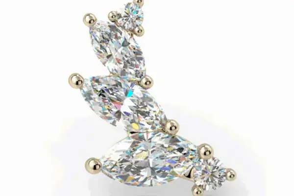 The 14K Small Sabine is a gold earring with five clear gemstones in varying shapes and sizes, set in a curved, ascending design, shown against a white background.