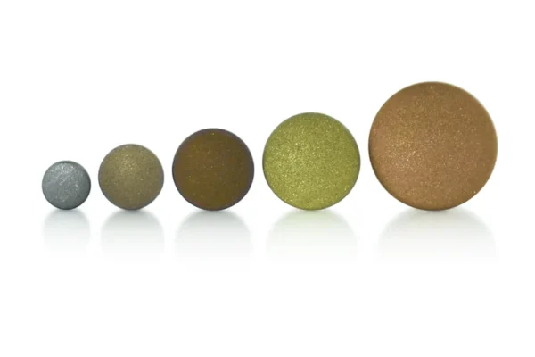 A set of five Texturized Disks in round, metallic colors, arranged by increasing size on a white background. The discs display shades from silver to gold to bronze.