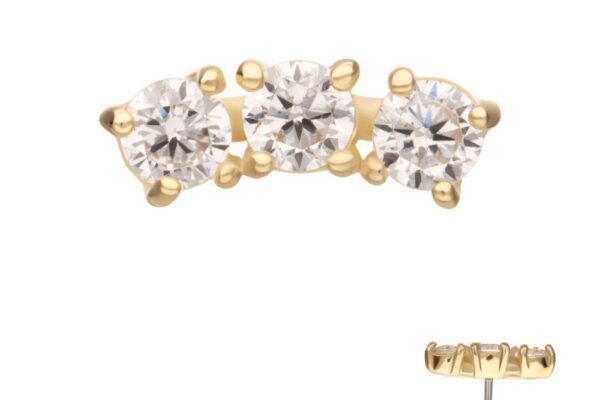 The 14K Triple Gem Cluster gold stud earring features three clear round gemstones in a row. Images display the earring from the side and as a pair, showcasing its sparkling stones and elegant gold setting.