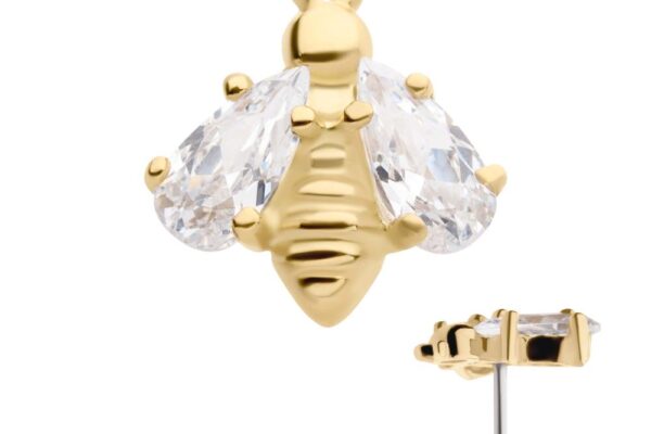 The 14K Bee stud earring showcases a gold bee design with clear, teardrop-shaped crystal wings and a textured body; the side profile of the earring post is pictured.