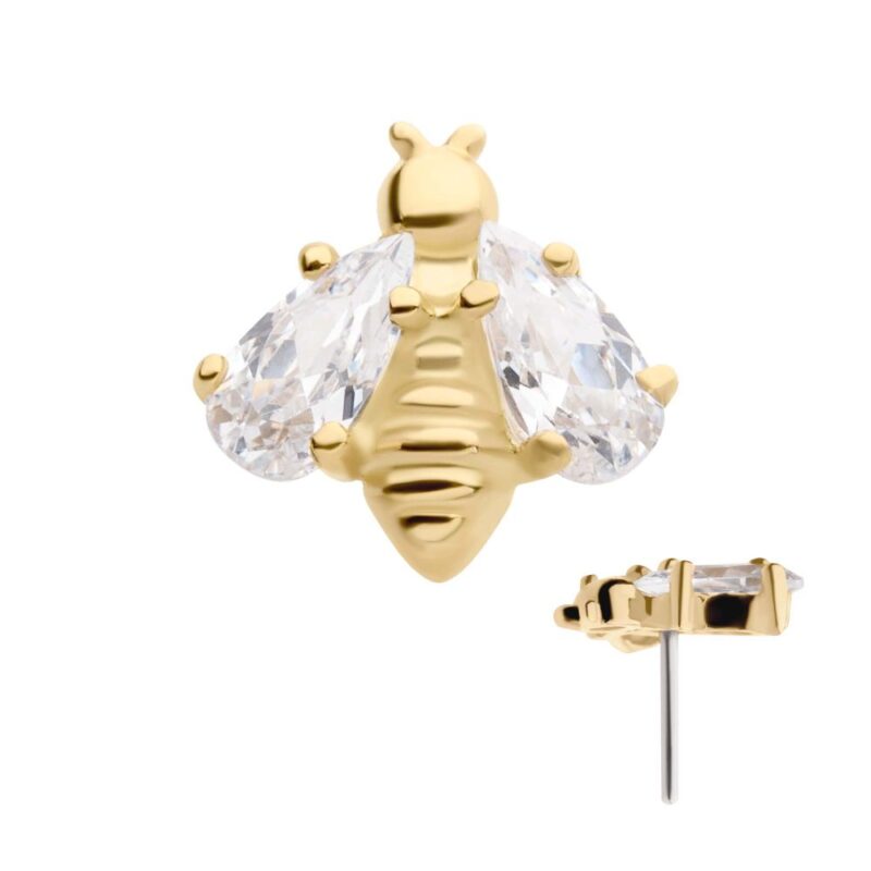 The 14K Bee stud earring showcases a gold bee design with clear, teardrop-shaped crystal wings and a textured body; the side profile of the earring post is pictured.
