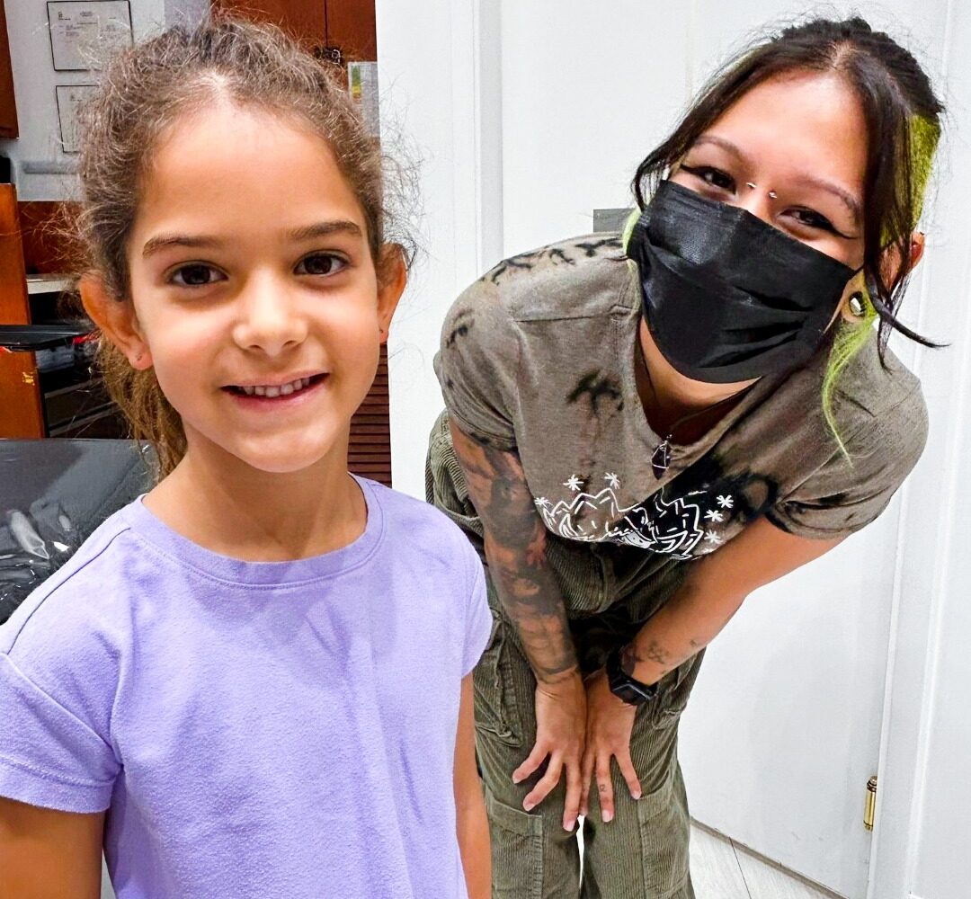 Child with guardian consulting for piercing appointment at Master Pierce