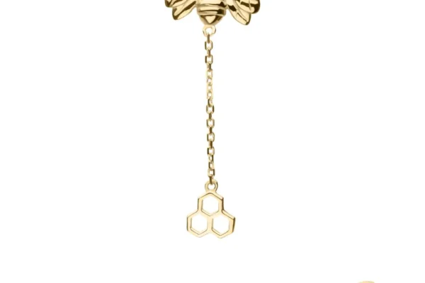 The 14K Honeycomb & Bee Chain Dangle features a graceful bee linked by a delicate chain to a honeycomb design, combining elegance and charm in one unique brooch.
