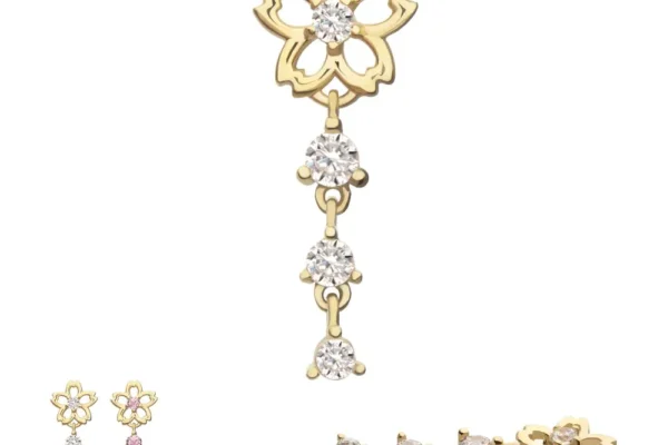 The 14K Cherry Blossom Flower Dangle showcases a delicate flower design with three round gems on a dangling chain. The main image displays white stones, with pink and white options below and a side view at the bottom right.