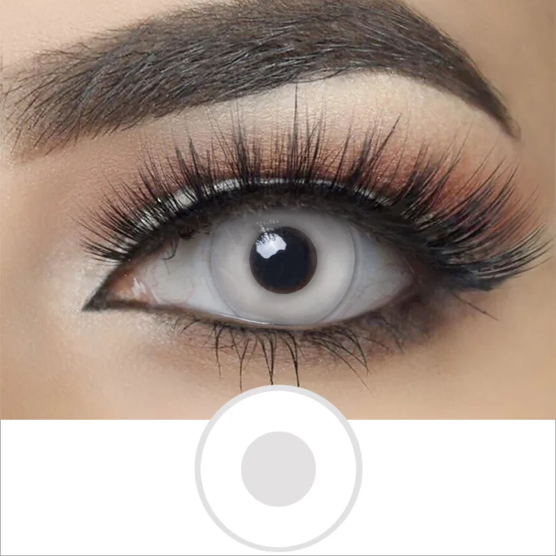 A close-up of an eye with dramatic makeup and long lashes, showcasing Magister - White Out lenses that fully cover the iris and pupil for a bold, otherworldly look.
