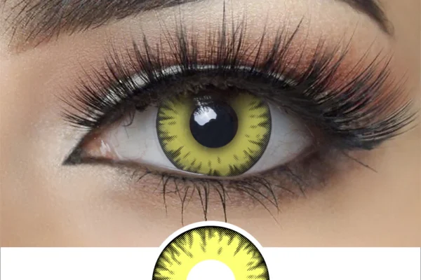 Close-up of an eye with dramatic makeup, long lashes, and a Magister - New Moon Twilight contact lens in yellow with a bold black rim and radiating streaks for a vivid, striking look.