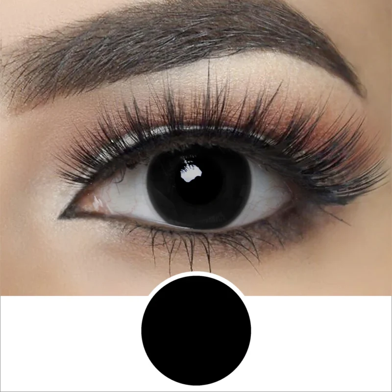 Close-up of a person’s eye with bold makeup and long lashes, featuring a solid black iris created by Magestri - Blind Black contact lenses, perfectly matching the black circle beneath the eye.
