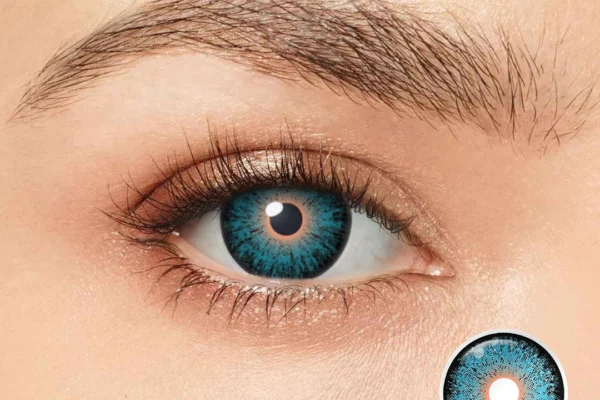 A close-up of an eye wearing the Magister - E.T Eye contact lens, featuring a vivid blue radial design and dark outer ring. An enlarged image of the lens appears in the corner, labeled MY49.