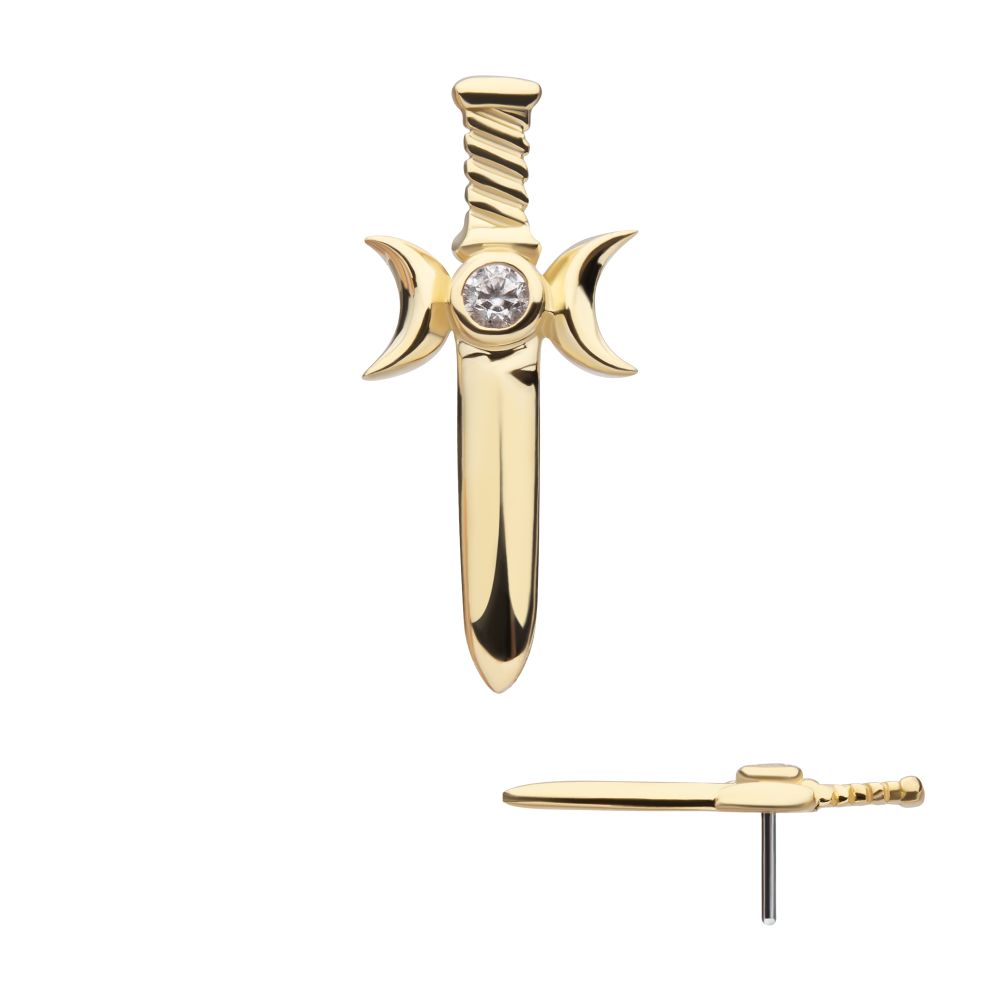 The 14K Triple Moon Dagger earring, shaped like a gold sword with crescent moons on each side and a clear center gemstone, is shown from front and side views against a white background.