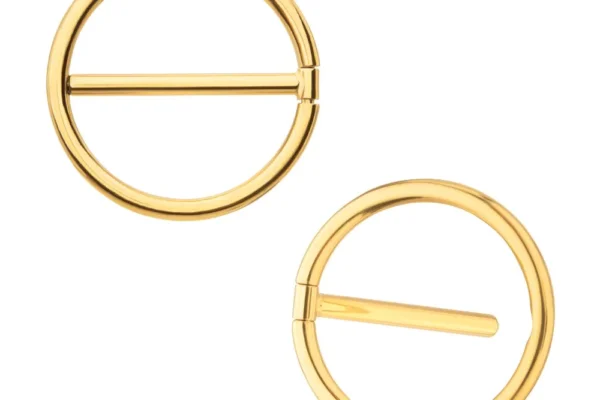 Two Gold Nipple Clicker Rings, featuring a minimalist round design with a central bar, are displayed on a white background.