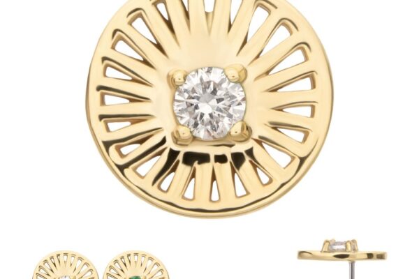 The 14K Radiant Circle with Gem earrings feature a sunburst gold design with central gems—one clear diamond, one green stone. Side view displays the post and gemstone setting.