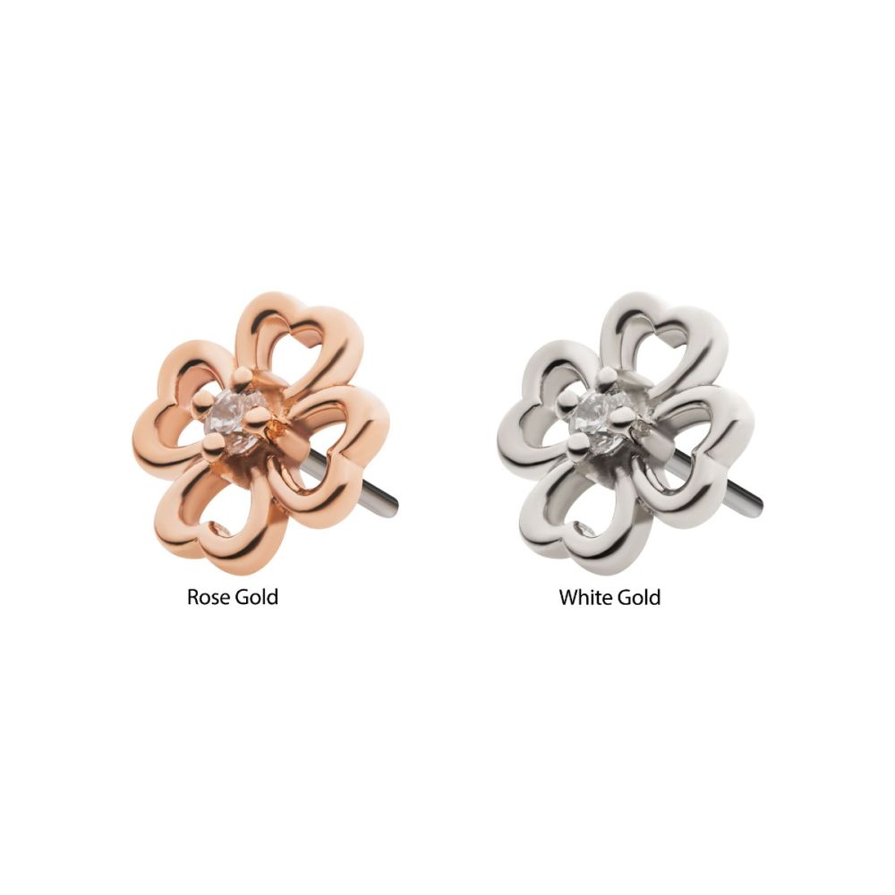 Two 14K Four Leaf Clover Hollow earrings are shown side by side; the left is rose gold and the right is white gold. Each has heart-shaped petals with a small central gem. Labels read Rose Gold and White Gold. Two 14K Four Leaf Clover Hollow earrings are shown side by side; the left is rose gold and the right is white gold. Each has heart-shaped petals with a small central gem. Labels read Rose Gold and White Gold.