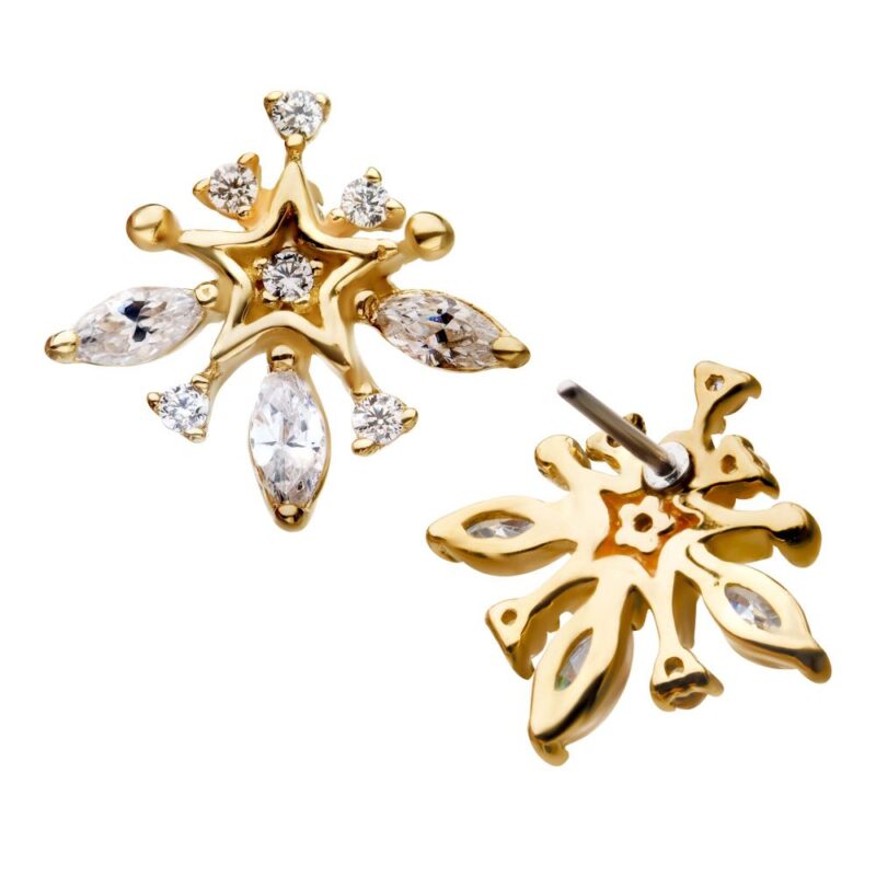 The 14K Marquise Starburst features gold stud earrings with snowflake-inspired shapes, clear marquise-cut and round gemstones in a symmetrical design. One earring is displayed from the front, the other from the back.
