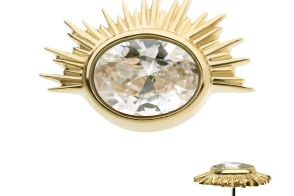 The 14K Oval Starburst earring features a gold sunburst design with spiky rays and a prominent oval-cut clear gemstone at the center, highlighted by a raised setting and secure post fastening.