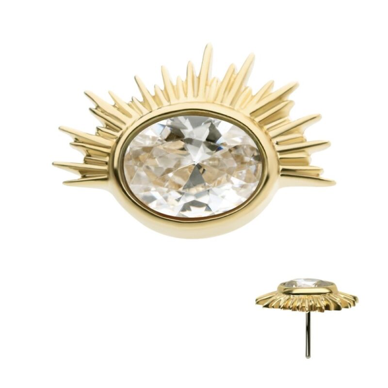 The 14K Oval Starburst earring features a gold sunburst design with spiky rays and a prominent oval-cut clear gemstone at the center, highlighted by a raised setting and secure post fastening.