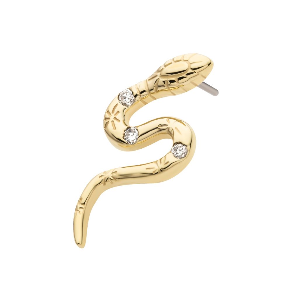 The 14K Snake – Gem is a gold snake-shaped earring featuring engraved details and three clear gemstones along its body, displayed on a white background. The 14K Snake – Gem is a gold snake-shaped earring featuring engraved details and three clear gemstones along its body, displayed on a white background.