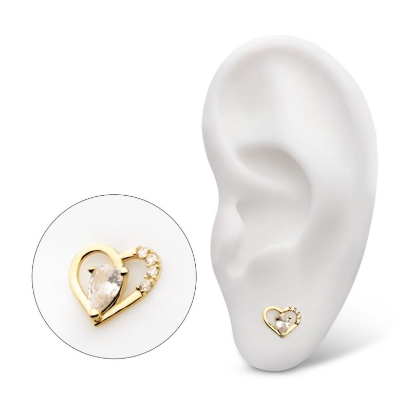The 14K Royal Teardrop Heart earring, featuring a gold heart shape with a pear-shaped gemstone and small diamonds, is displayed on a white ear model, with a close-up showcasing its elegant details.