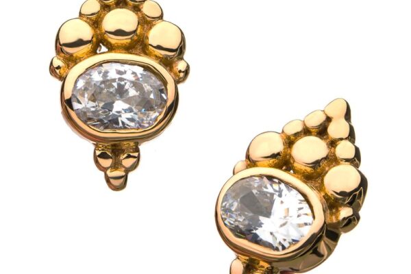 The 14K Beaded Cluster features gold stud earrings with an intricate beaded design and a large oval-shaped clear gemstone at the center, showcased against a white background.