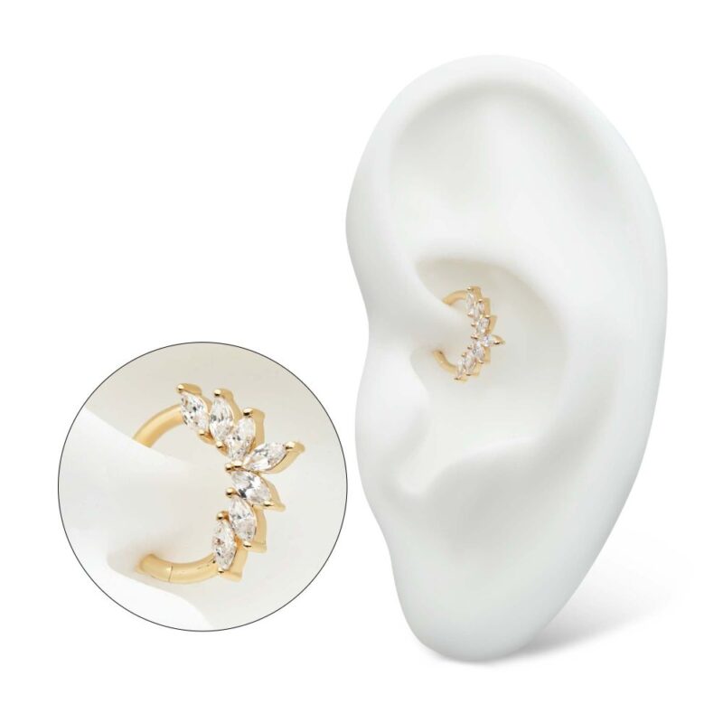 The 14K Marquise Wreath Clicker ear cuff, adorned with multiple marquise-cut clear stones, is displayed on a white ear-shaped stand and highlighted in a close-up circular inset.