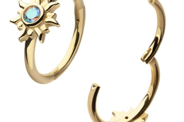 Two 14K Sunburst Side Clicker gold open hoop rings, each with a sun-shaped design and a central blue gemstone, are displayed on a white background.