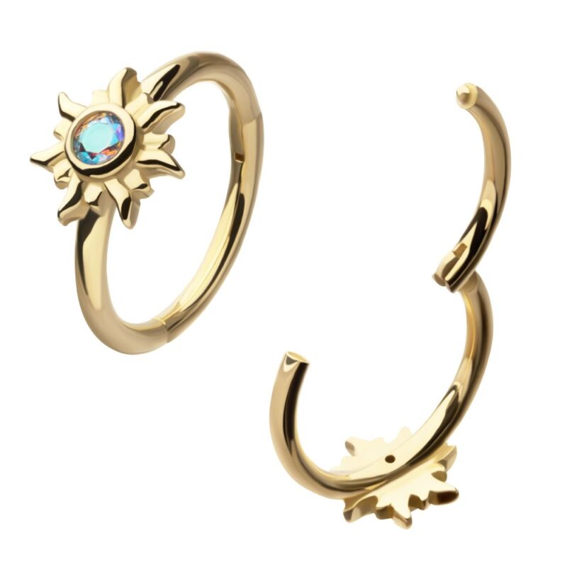 Two 14K Sunburst Side Clicker gold open hoop rings, each with a sun-shaped design and a central blue gemstone, are displayed on a white background.