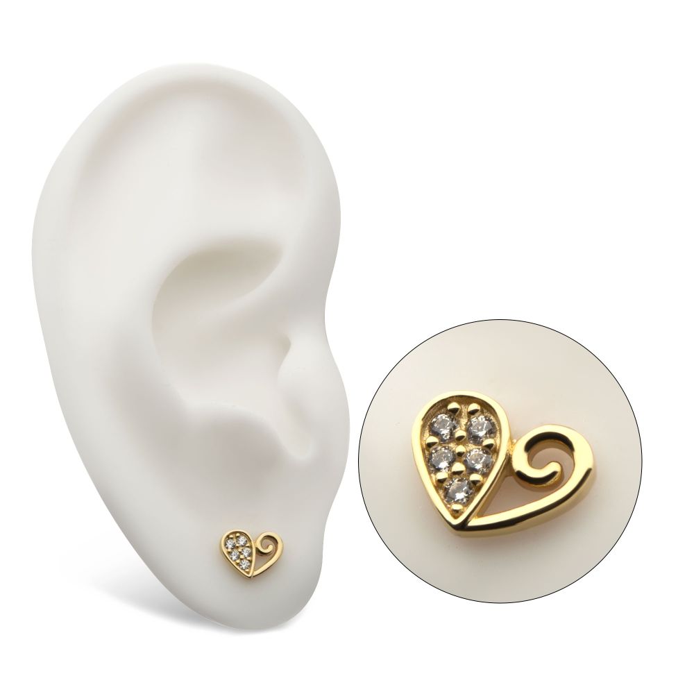 The 14K Half Gem Heart earring, shaped like a gold heart with embedded gems, is displayed on a white ear model. An inset circle highlights the earring’s sparkling stones and elegant, shiny design. The 14K Half Gem Heart earring, shaped like a gold heart with embedded gems, is displayed on a white ear model. An inset circle highlights the earring’s sparkling stones and elegant, shiny design.