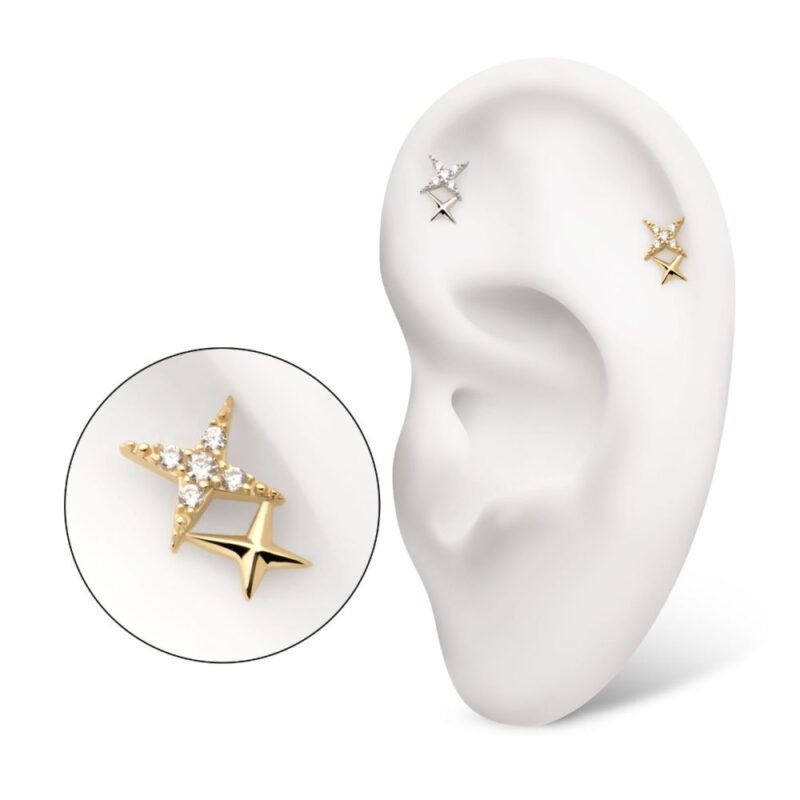 A white model ear displays the 14K Double Celestial Star earring: one star in plain gold, the other encrusted with diamonds. A close-up inset highlights both the gleaming gold and sparkling gems.
