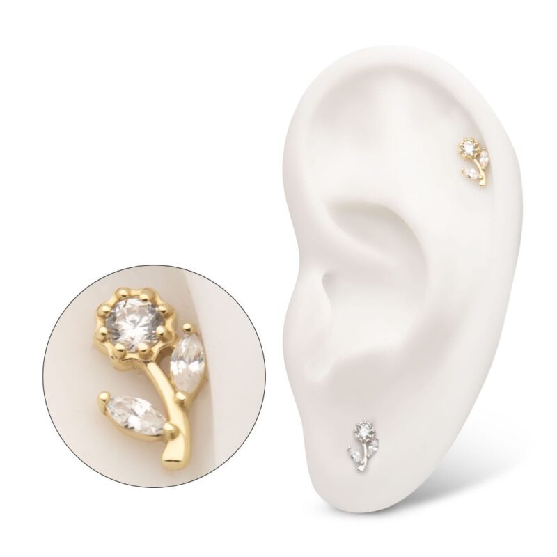 A white ear model displays the 14K Rose Flower earring on the upper ear. An inset shows a close-up of the gold earring featuring a central round gem and two marquise-shaped gems as leaves.