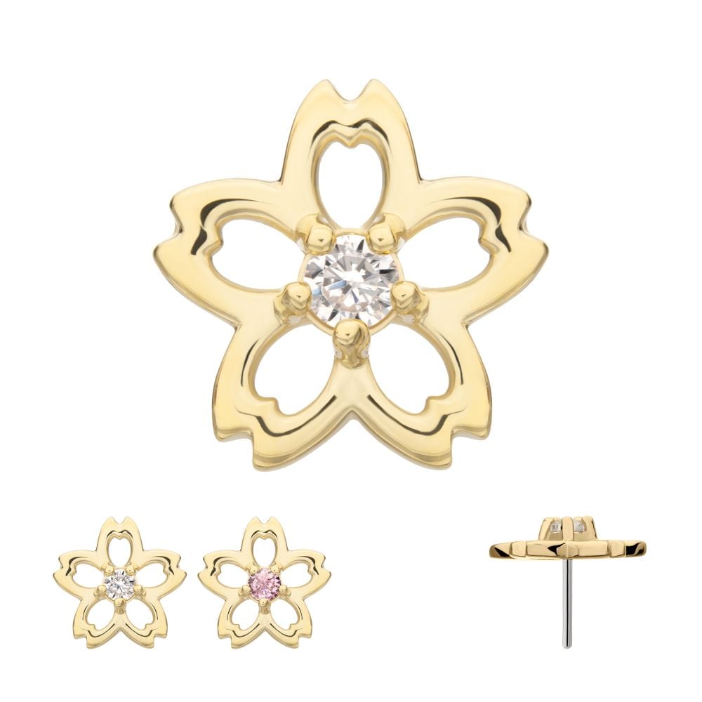 The 14K Cherry Blossom is a gold flower-shaped stud earring shown from front, back, and side views. One variant features a pink center stone, while another has a clear center stone.
