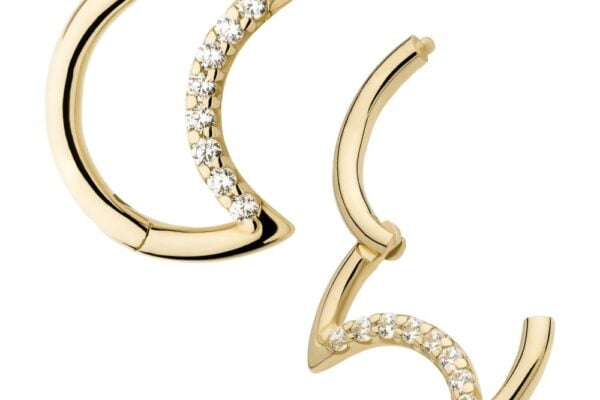 The 14K Crescent Moon Gem Clicker features gold crescent moon earrings, each lined with clear gemstones along the inner curve. One earring is displayed closed, while the other is shown open.
