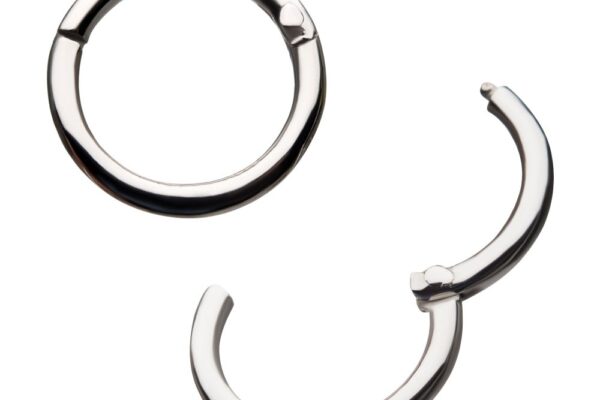 The 14K Basic Clicker - WG features two small, silver-toned hoop earrings: one fully closed in a circle, the other partially open to display its hinged clicker design. Both have a smooth, polished finish.