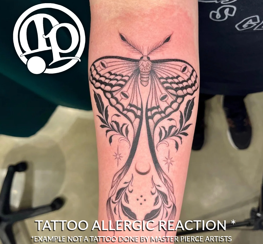 A close-up of a forearm with a large black ink moth tattoo showing redness and irritation around the design, which can vary depending on tattoo pain levels. Text at the bottom reads: “TATTOO ALLERGIC REACTION *Example not a tattoo done by Master Pierce Artists.”.