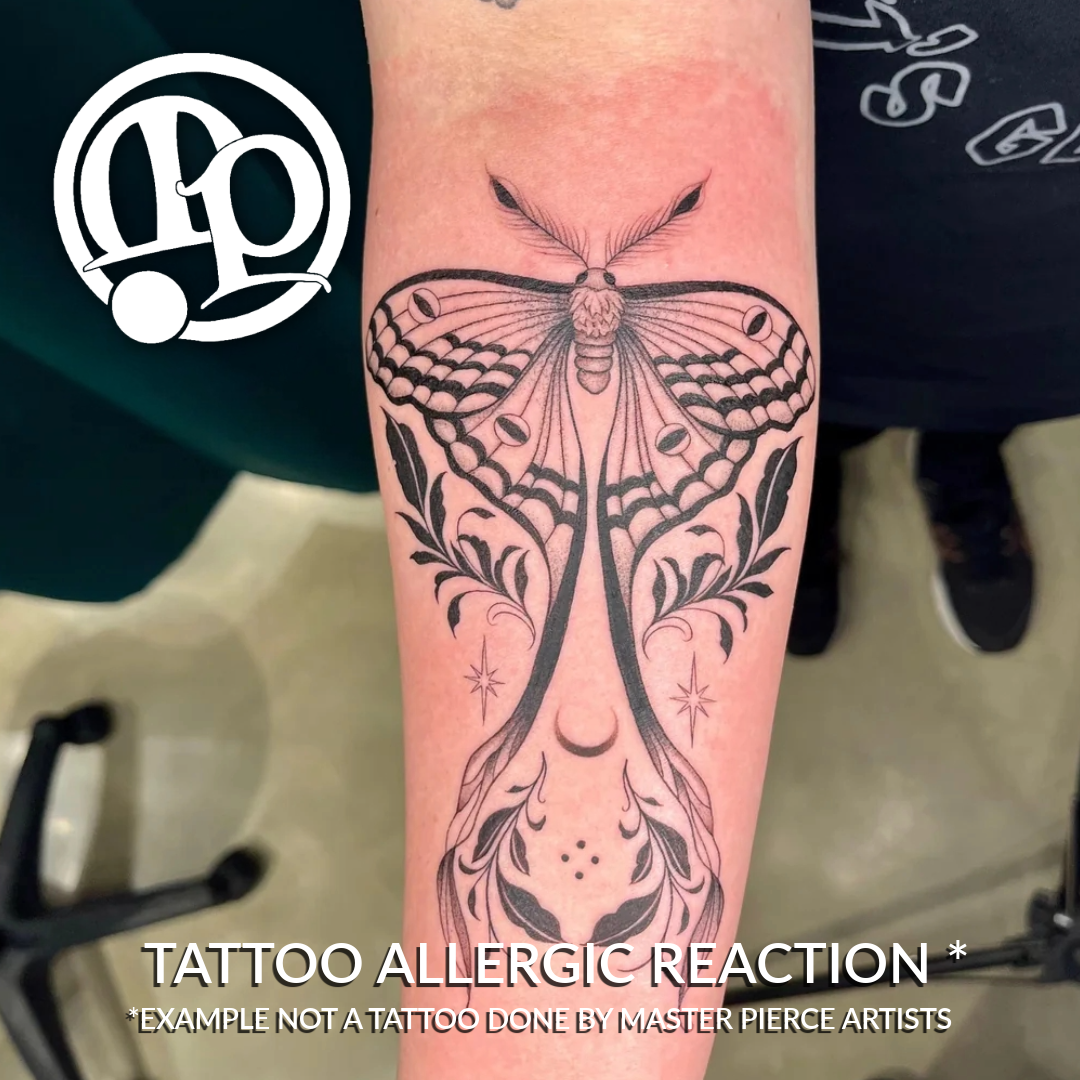A close-up of a forearm with a large black ink moth tattoo showing redness and irritation around the design, which can vary depending on tattoo pain levels. Text at the bottom reads: “TATTOO ALLERGIC REACTION *Example not a tattoo done by Master Pierce Artists.”.