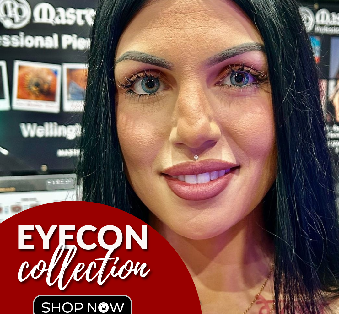 A woman with long dark hair and striking light-colored eyes smiles at the camera; behind her are promotional displays. A red circle in the corner reads: EYECON collection SHOP NOW.