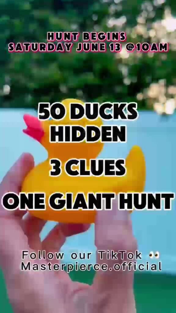 A hand holds a yellow rubber duck with text announcing a hunt for 50 hidden ducks, 3 clues, and one giant hunt. The event begins Saturday, June 13 at 10am. Social media info is at the bottom.